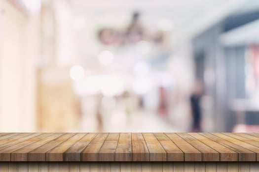 Wood table top on blurred background from shopping mall, Space for montage your product. photo