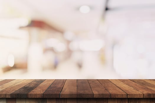 Wood table top on blurred background from shopping mall, Space for montage your product. photo