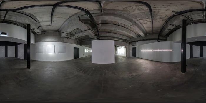 seamless spherical hdri 360 panorama in dark interior of large empty room as warehouse, hangar or gallery with spotlights in equirectangular projection. VR AR concept photo