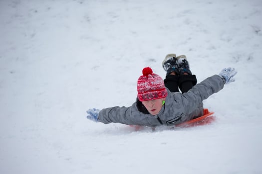 Child in winter. The boy is sledding. photo