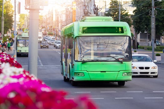 Green trolleybus rides through the streets of the city. photo