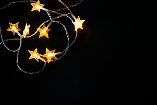 Christmas background with lights and space for free text. Christmas lights from a garland on a black background. photo