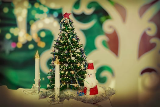 Vintage christmas background with fir tree candles and toy santa claus. photo