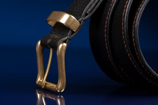 Black leather belt on a dark blue background. photo
