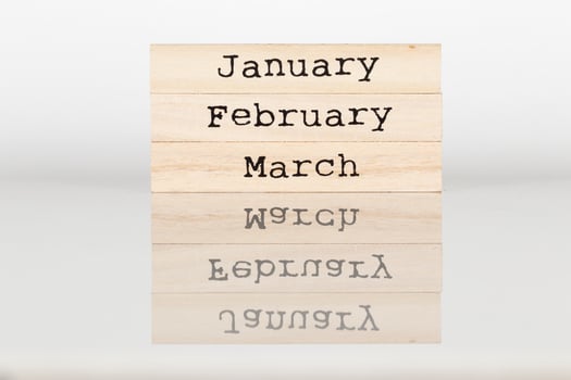 wooden cube with the inscription January, February, March on a white background photo