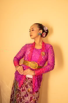 Balinese woman wearing a pink dress called kebaya from Indonesia's traditional dresses photo