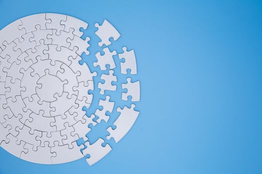 Unfinished white jigsaw puzzle pieces on blue background, The last piece of jigsaw puzzle, Copy space. photo