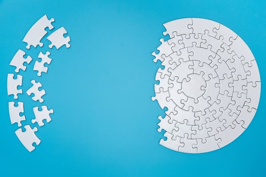 Unfinished white jigsaw puzzle pieces on blue background, The last piece of jigsaw puzzle, Copy space. photo
