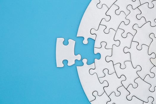 Unfinished white jigsaw puzzle pieces on blue background, The last piece of jigsaw puzzle, Copy space. photo