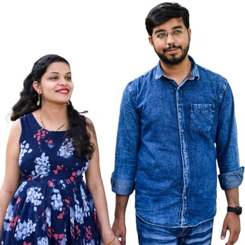 Indian couple posing for maternity baby shoot with white plain background. The couple is posing in a lawn with green grass and the woman is falunting her baby bump in Lodhi Garden in New Delhi, India photo