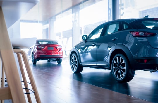 Rearview car parked in luxury showroom. Car dealership office. New car parked in modern showroom. Auto for sale and rent business concept. Automobile leasing and insurance concept. Car dealer company. photo