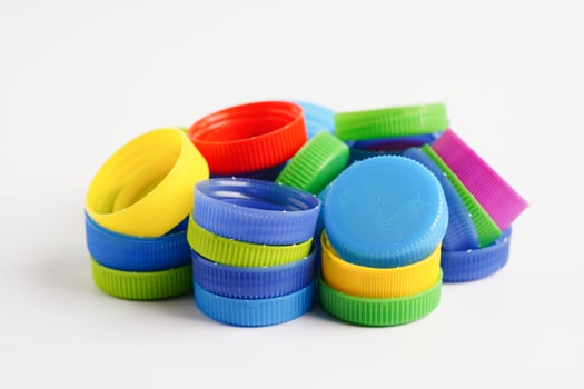 Plastic bottle caps colorful for recycle on white background. photo
