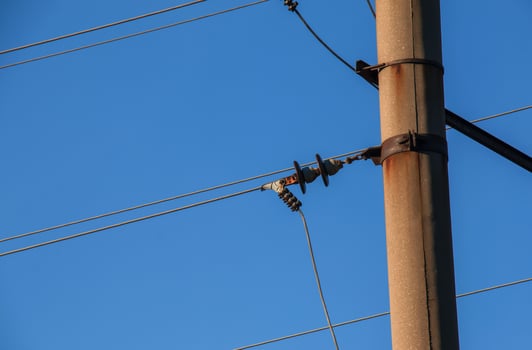 Electric pole with a linear wire against the blue sky close-up. Power electric pole. photo