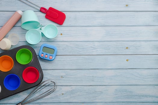 Top view set of kitchen utensils and ingredients for bakery on blue wooden floor. Materials or kitchen equipment for bakery. photo
