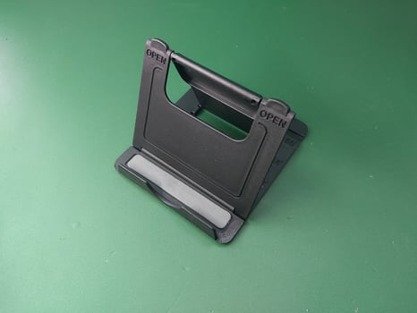 Plastic stand for smartphone spins photo