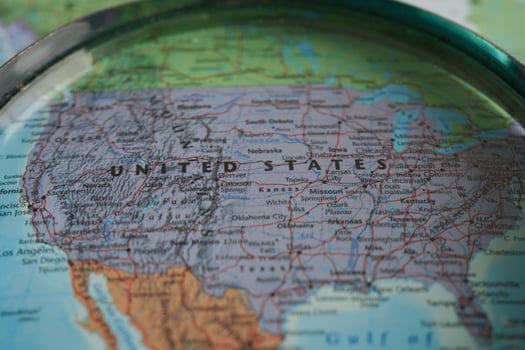 Bangkok, Thailand - May 15, 2022 Magnifying glass on world map. photo