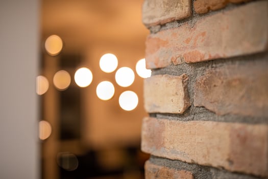 Blurred lamp lights with brick wall background, modern interior design. Closeup architecture view photo
