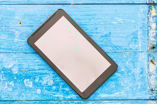 smartphone with clean screen on a blue wood background photo