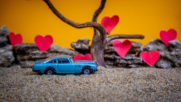 Minahasa, Indonesia December 2022, toy car with gradient orange background and a heart photo