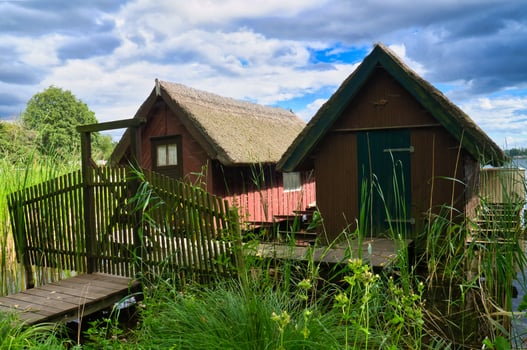 Fishing lodge on the lake near Krakow on the lake. Inland fishing. Vine roof on the house photo