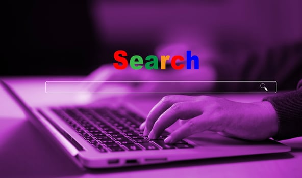 Hand type laptop and Searching Browsing Internet Data Information with blank search bar. man's hands are using smartphone and keyboard to Searching for information. Using Search Console with website. photo