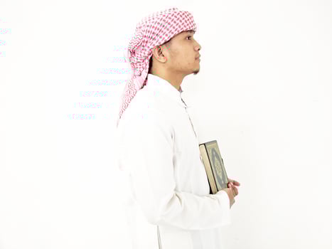 Man Holding and reading quran. Islamic Background photo