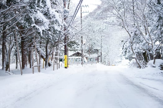 Nikko, JAPAN - 26 JANUARY 2023. tungsten lamp and a Japanese village sign, heavy snow Covered Road at Heike No Sato Village in Tochigi Prefecture, Nikko City, photo