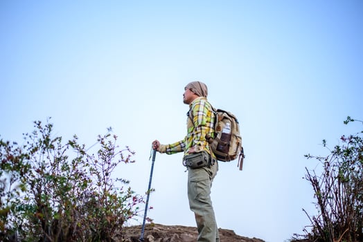 Portrait of Man hiking mountains with backpack photo
