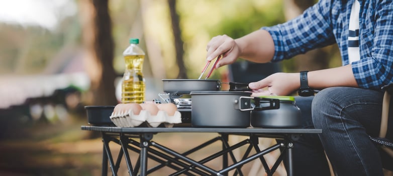Asian traveler man glasses frying a tasty fried egg photo
