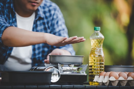 Portrait of Asian man glasses cooking at campsite photo