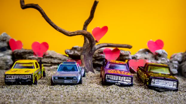 Minahasa, Indonesia  December 2022, toy car with gradient orange background and a heart photo