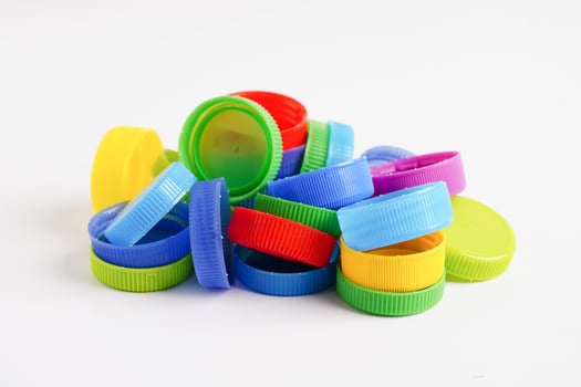 Plastic bottle caps colorful for recycle on white background. photo