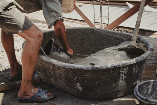 worker mixing cement mortar plaster for construction photo
