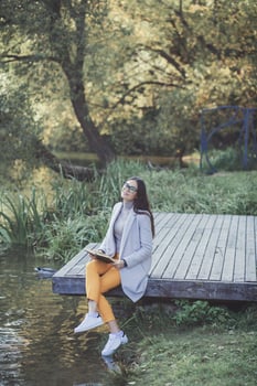 woman with glasses reading a book photo