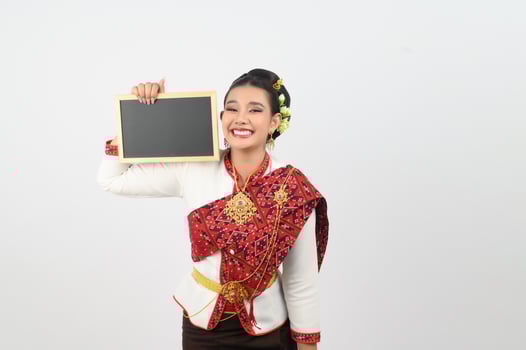 Portrait of Beautiful Thai Woman in Traditional Clothing Posing with blackboard photo