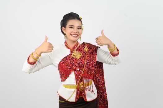 Young beautiful woman in Thai lanna costume with thumb up posture photo