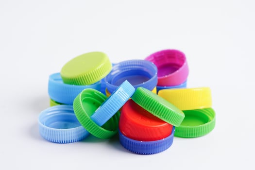 Plastic bottle caps colorful for recycle on white background. photo