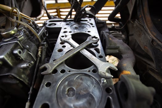 Mercedes diesel engine repair. Hands with a mechanic repairing Mercedes parts. Disassembled old engine. photo