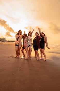 a group of Indonesian women enjoy the beach happily when they meet their friends at the holiday moment photo