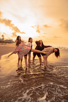 a group of Indonesian women enjoy the beach happily when they meet their friends at the holiday moment photo