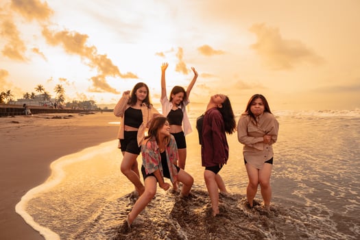 a group of Asian women enjoying their holiday very crazy with their friends and with a full expression of silliness on the beach photo