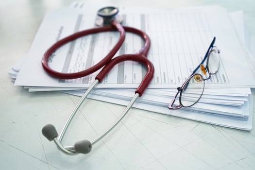 Red stethoscope and eyeglass on drug test photo