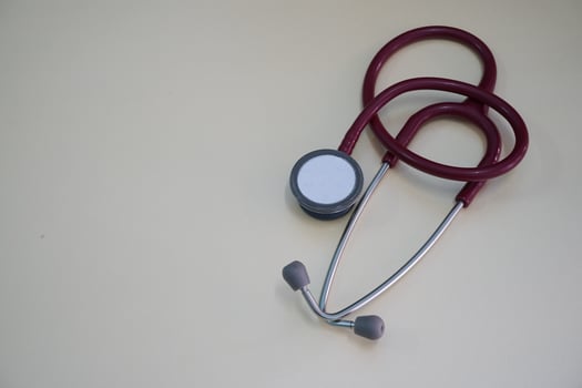 Red stethoscope on white background in clinic photo