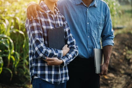 Asian woman and man farmer working together in organic hydroponic salad vegetable farm. using tablet inspect quality of lettuce in greenhouse garden. Smart farming photo