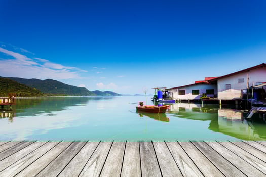wood bridge and orange boat on sea at koh chang thailand. photo