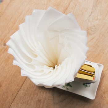 Tissue paper on wood table in coffee shop photo