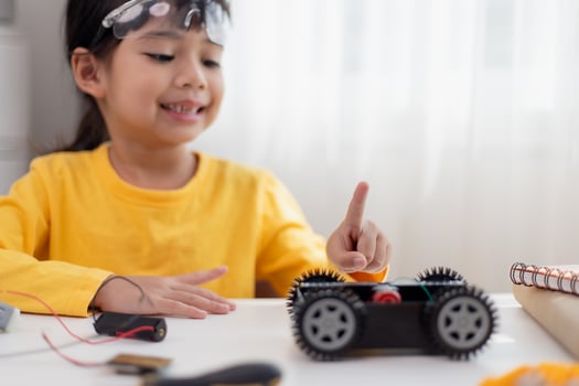 Asia students learn at home in coding robot cars and electronic board cables in STEM, STEAM, mathematics engineering science technology computer code in robotics for kids concept. photo