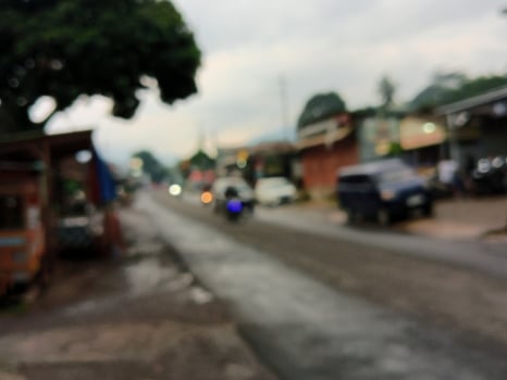 Blurred street in evening with vehicle's light photo