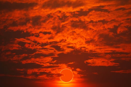 Total solar eclipse on red orange sky sunset in the evening photo