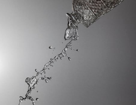 Falling water on a silver background photo